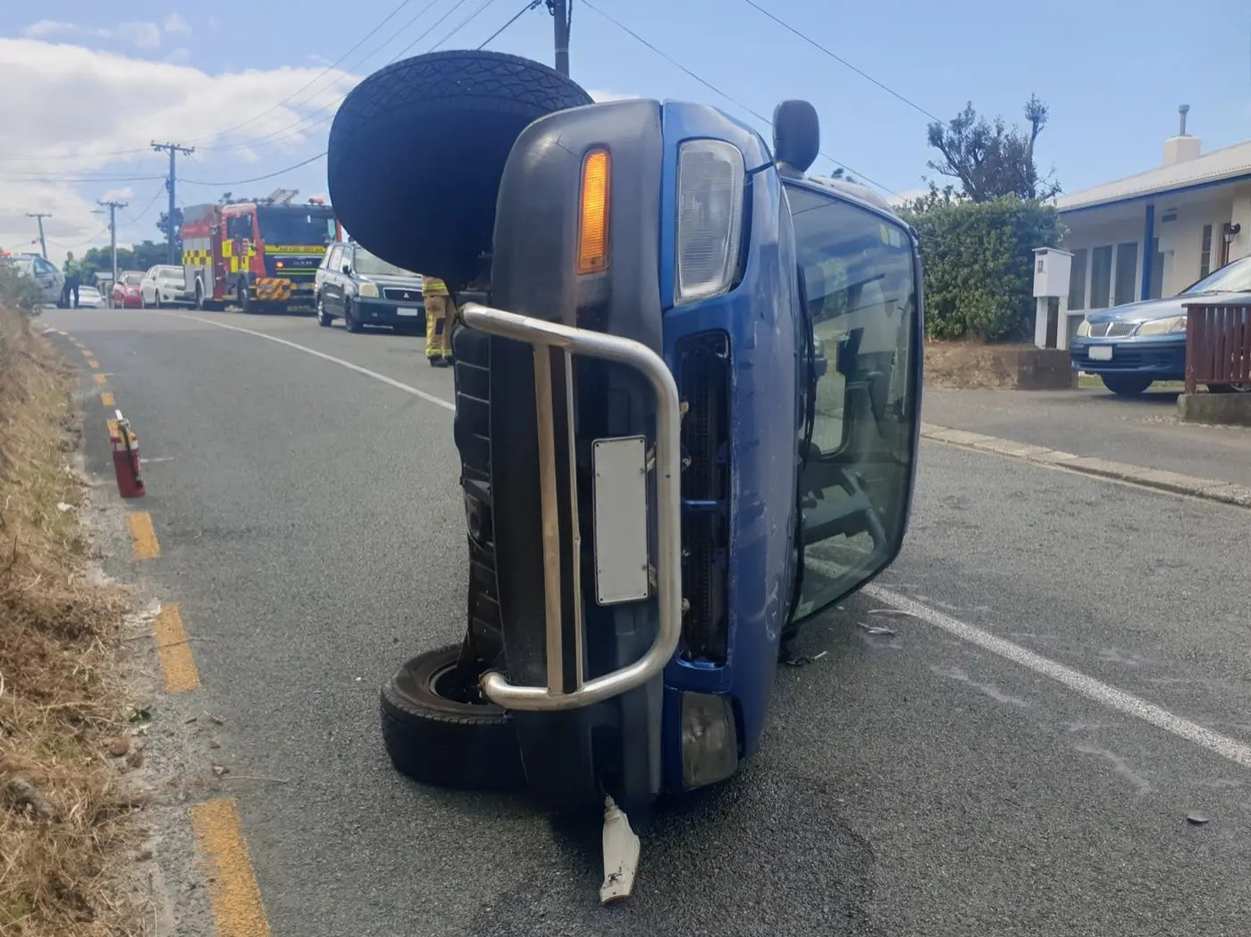 A damaged car at the scene of an accident, with number plates removed.