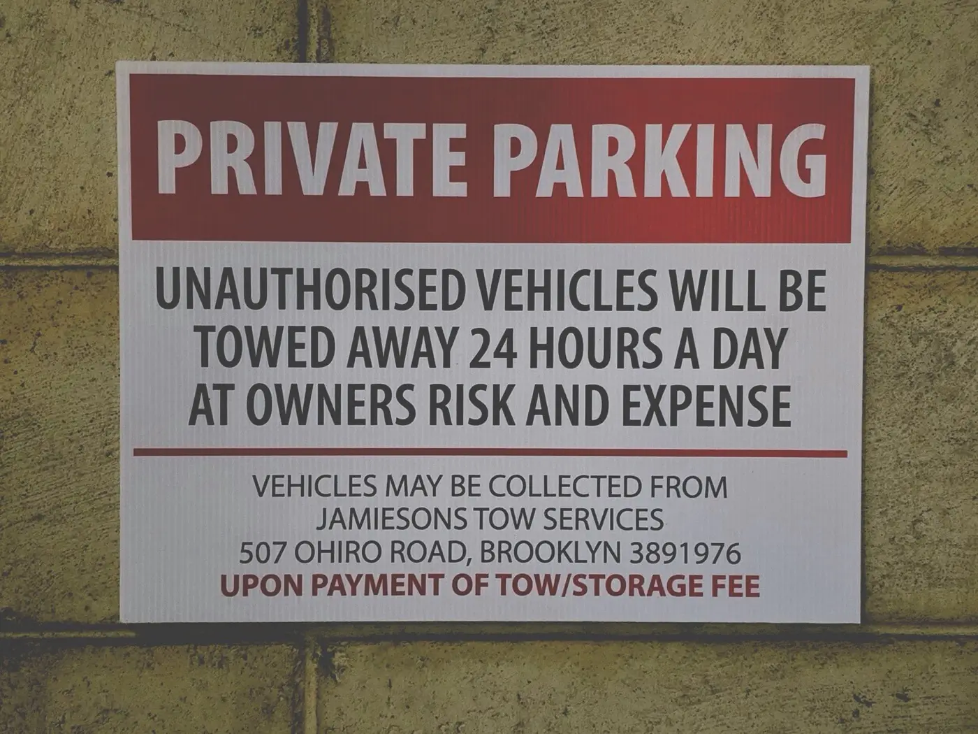 A Jamieson's private parking warning sign giving the yard address for vehicle collection.