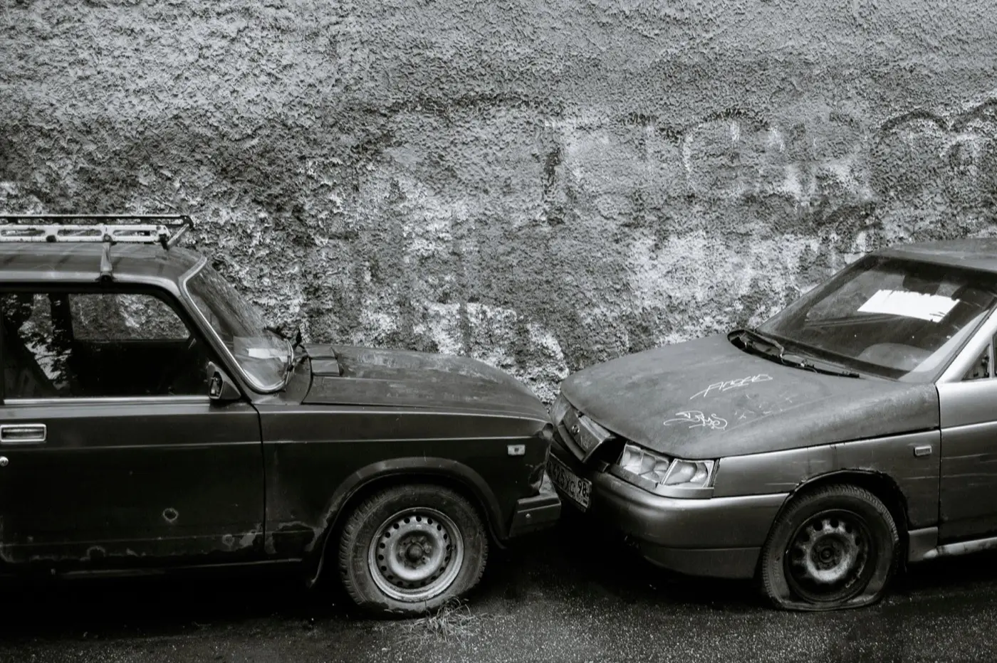 Two damaged cars, nose to nose.